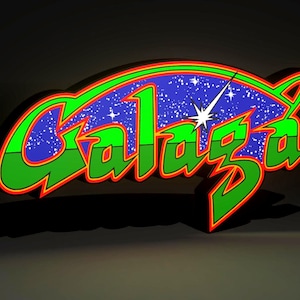 Może przedstawiać: Trójwymiarowy znak z napisem "Galaza" w kolorze zielonym, obramowanym na czerwono, na niebieskim tle z białymi gwiazdami. Znak ma grafikę rozbłysku gwiazdy i zielono-czerwony kontur.