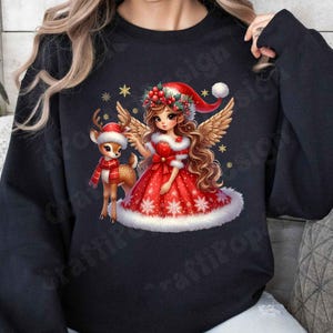 May include: Black sweatshirt featuring a Christmas-themed illustration. The design includes a girl in a red dress and Santa hat with a reindeer wearing a scarf. The girl has angel wings and is surrounded by snowflakes and stars.