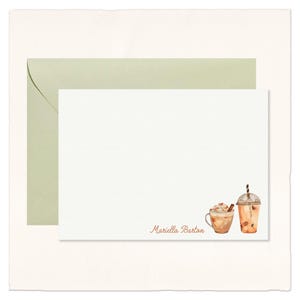 May include: Stationery set featuring a white card and a pale green envelope. The card has a watercolor illustration of a coffee drink and an iced coffee. The name "Mariella Barton" is printed in a brown script font.