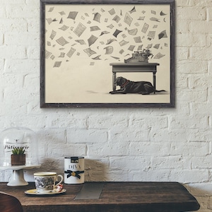 May include: A framed print featuring a black dog lying under a table with a vintage typewriter. Papers float in the air. The print is set against a white brick wall. A cup of coffee and a decorative cake stand are on a wooden table.
