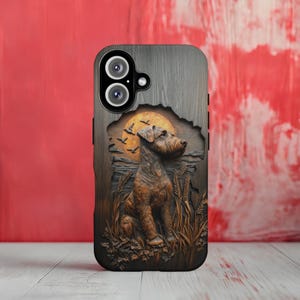 May include: A phone case with a detailed, carved design featuring a dog sitting in a field with a sunset backdrop. The case has a wood-grain texture and a dark brown and tan color scheme. The phone's camera lenses are visible at the top.