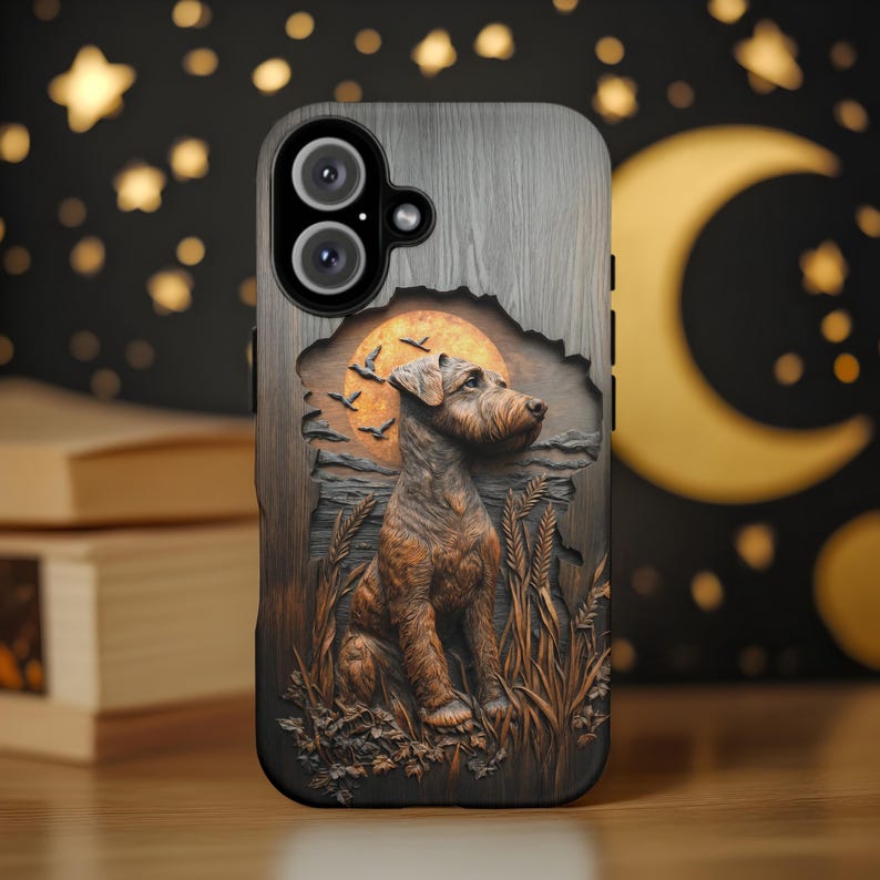 May include: A phone case with a detailed relief of a dog sitting in a field, with a sunset and birds in the background. The case has a wood-grain texture and a black border. The dog is brown and the sunset is orange.