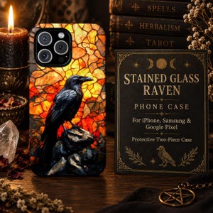 May include: A phone case featuring a black raven perched on a rock against a background of orange and yellow stained glass patterns. Next to it is a black rectangular card with the text STAINED GLASS RAVEN PHONE CASE for iPhone, Samsung & Google Pixel.