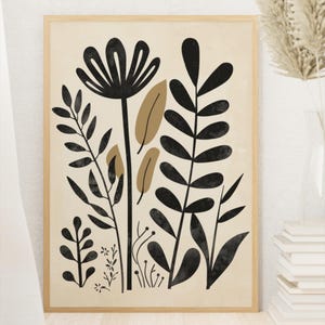 May include: A framed botanical art print. The artwork features a beige background with black and tan plant illustrations. The plants include large stylized flowers and various leaf shapes. The frame is made of light wood, creating a minimalist aesthetic.