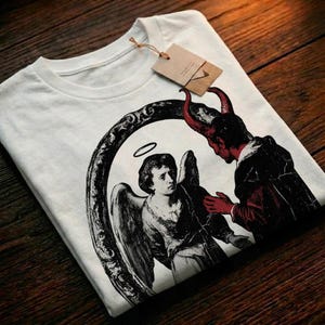 May include: A white ceramic mug with a black handle and the text "But First, Coffee" in a handwritten style. The mug is on a white surface. The mug is approximately 4 inches tall.