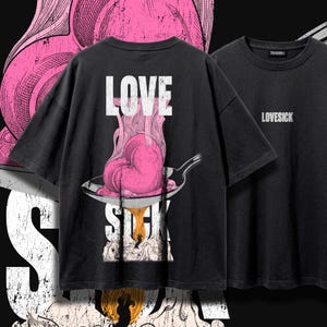 Puede incluir: Una camiseta negra con un gráfico en la espalda de un corazón rosa derritiéndose en una sartén con el texto LOVE SICK en letras blancas. La parte delantera de la camiseta muestra la palabra LOVESICK en letras blancas pequeñas en el pecho.