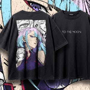May include: A black short-sleeve t-shirt featuring a large graphic print on the back of an anime character with light blue hair and a purple top, surrounded by manga panels. The front of the shirt displays the white text TO THE MOON.