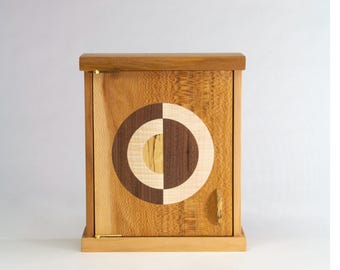 Small sycamore hand-built wall cabinet with an inlay design of walnut and maple.