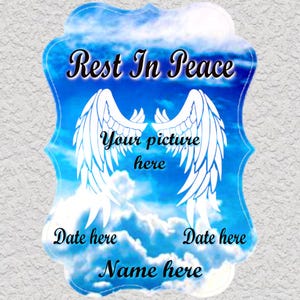 May include: A blue and white memorial plaque with a cloud background and angel wings. The text "Rest In Peace" is at the top. There are spaces for a name, dates, and a picture.