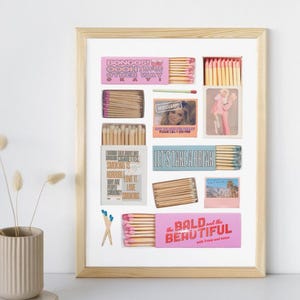 May include: A framed collage of matchboxes with various designs and colors. The matchboxes feature phrases like "Bongos! Ooh This Other Way", "Let's Take a Break", and "The Bald and the Beautiful".