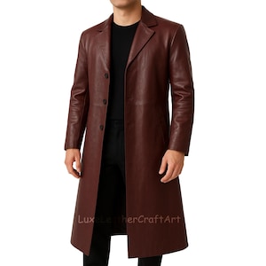 May include: A burgundy leather trench coat with a classic design. The coat features a notched collar, button closure, and a knee-length hem. The text "LuxeLeatherCraftArt" is visible at the bottom of the coat.