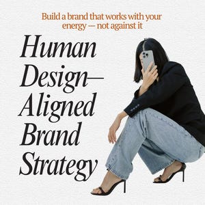 May include: Image with the text "Human Design-Aligned Brand Strategy" and the tagline "Build a brand that works with your energy - not against it." A person in a black blazer and jeans is holding a phone.