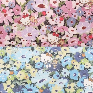 May include: A fabric pattern featuring two distinct sections. The top section displays pink, purple, and white flowers with Hello Kitty characters. The bottom section shows blue, yellow, and green flowers with Hello Kitty characters and small orange apples.