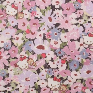 May include: A fabric pattern featuring a dense floral print in shades of pink, lavender, and white against a dark background. The design includes repeated illustrations of the character Hello Kitty wearing a red bow and holding a small teddy bear.