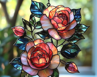 May include: Stained glass rose window with two large blooms and two buds. The petals are shades of red, orange, and pink, with green and blue leaves. The window hangs from a chain.
