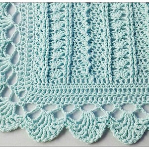 May include: A light blue crocheted blanket with a scalloped edge. The blanket is made with a delicate stitch pattern and has a soft, airy feel.