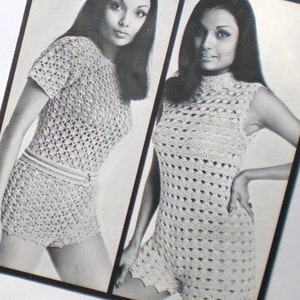May include: Two women wearing crocheted dresses. The dresses are white and have a geometric pattern. The women are both wearing their hair long and straight.
