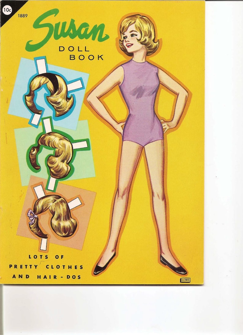 May include: A vintage paper doll book featuring Susan, with a yellow cover and the text "Susan Doll Book" and "Lots of Pretty Clothes and Hair-Dos".
