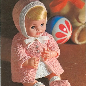 May include: A pink knitted doll coat with white trim and a matching pink knitted hat. The doll is wearing a white dress and pink socks. The pattern is for a 12 or 14 inch doll. The pattern is from Coats Carefree Bri-Nylon 4 Ply yarn. The pattern number is 3040 and costs 9d.