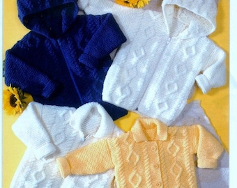 May include: Three knitted baby jackets in blue, white and yellow. The jackets feature a cable knit pattern and all have hoods.