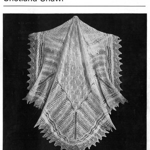 May include: A white crocheted Shetland shawl with a delicate lace pattern.