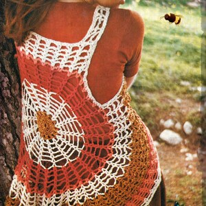 May include: A crocheted vest with a white, red, and brown color pattern. The vest is made with a delicate, open-stitch design.