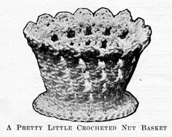 May include: A crocheted nut basket with a wide, open top and a round base. The basket is made of white yarn and has a delicate, lacy design.