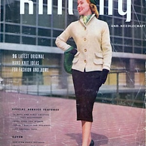 May include: A magazine cover featuring a woman wearing a white knitted jacket and a black skirt. The magazine is titled "SMART knitting AND NEEDLECRAFT" and features the text "96 LATEST ORIGINAL HAND KNIT IDEAS FOR FASHION AND HOME".