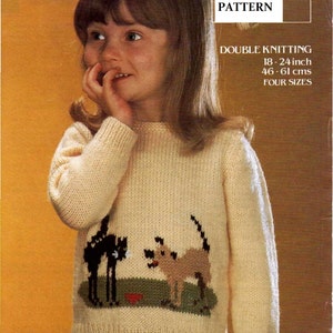 May include: A knitting pattern for a cream colored sweater with a black cat and a brown dog graphic. The pattern is for double knitting and includes four sizes, 18-24 inches or 46-61 cm.