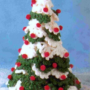 May include: A handmade crochet Christmas tree with white, green, and red accents. The tree is cone-shaped, with white sections resembling snow and green sections representing the branches. Red pom-poms are scattered throughout the tree, adding a festive touch.