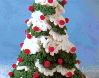 May include: A handmade crochet Christmas tree with white, green, and red accents. The tree is cone-shaped, with white sections resembling snow and green sections representing the branches. Red pom-poms are scattered throughout the tree, adding a festive touch.