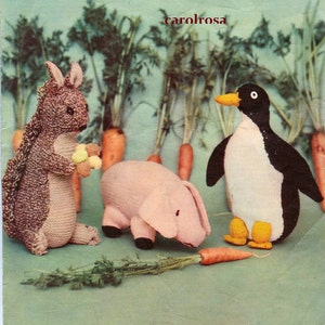 May include: A brown knitted squirrel holding a bunch of yellow flowers, a pink knitted pig, and a black and white knitted penguin with yellow feet. The animals are surrounded by green plants and orange carrots.