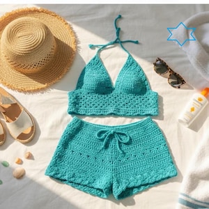 May include: A turquoise crochet bikini set with a halter top and shorts, alongside a straw sun hat, white sandals, sunglasses, and sunscreen. The set is displayed on a white surface, suggesting a beach or vacation theme.