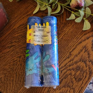 May include: Two rolls of blue wallpaper with a colorful cartoon design featuring a cat and the text "Jelly Bean Junction" and "Made in Canada 10758-1".