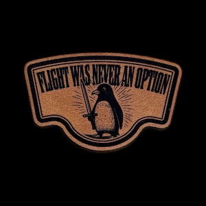 May include: A brown leather patch with the text "FLIGHT WAS NEVER AN OPTION" and a black penguin holding a sword. The penguin is centered, with a sunburst design behind it. The patch has a black border.