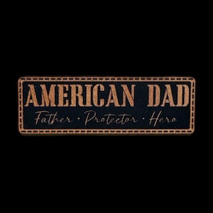 May include: A rectangular wooden sign with the words "AMERICAN DAD" in large, bold, capital letters. Below, in a smaller, cursive font, are the words "Father • Protector • Hero". The sign has a dark background and a stitched border.