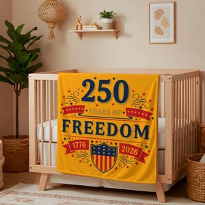 A nursery room with a wooden crib, a yellow blanket with a patriotic design, and various decorative elements such as a potted plant and a framed picture on the wall.