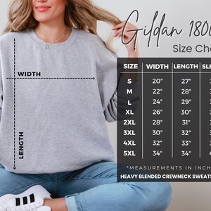 a woman wearing a gray crew neck sweatshirt, with a size chart displayed next to her.