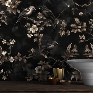 May include: Dark wallpaper featuring a floral and bird design in shades of black, brown, and white. The pattern includes detailed illustrations of flowers, leaves, and birds perched on branches. A wooden table displays decorative items.