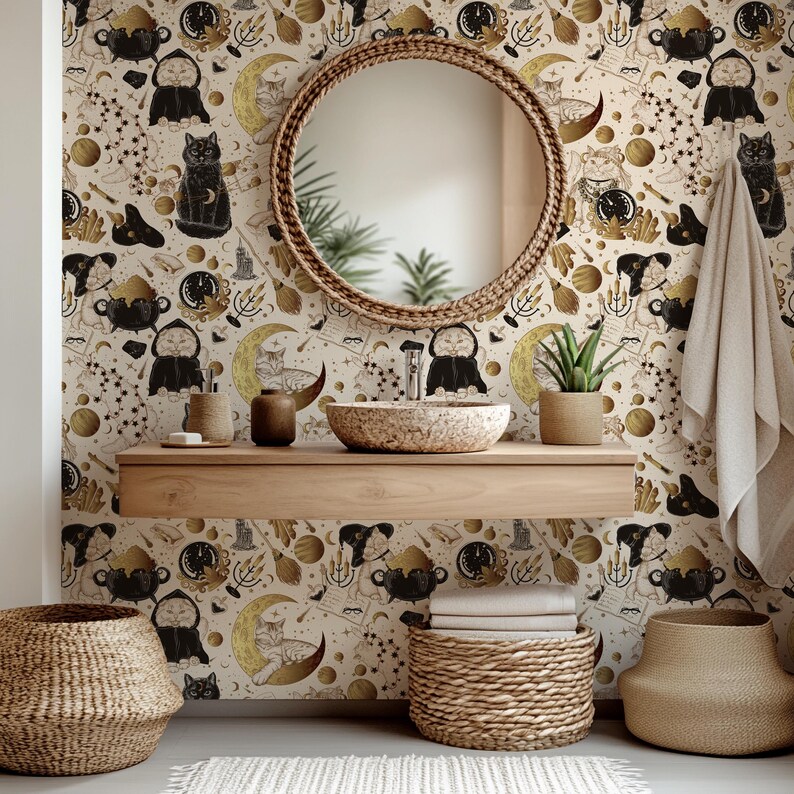 May include: A bathroom scene with patterned wallpaper featuring black cats, moons, and celestial motifs. A round woven mirror is above a stone sink and wooden shelf. Woven baskets and a plant complete the decor.