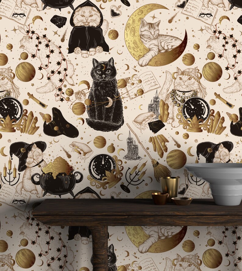 May include: A cream-coloured wallpaper with a repeating pattern of cats, moons, and stars in gold and black. The design incorporates mystical elements, with cats depicted in various poses alongside celestial and magical symbols.