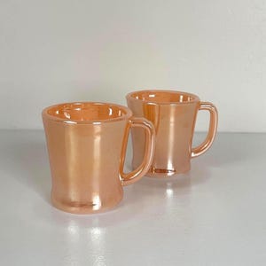 Pair Fire King Oven Ware Peach Lustreware D Handled Coffee Mugs