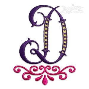May include: Embroidered letter D with a purple outline and a yellow and purple patterned centre. The letter is topped with a pink decorative flourish.