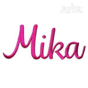 May include: A vibrant pink embroidered name, "Mika", in a flowing cursive style. The name is set against a white backdrop. The Apex Embroidery Designs logo is in the top right corner.