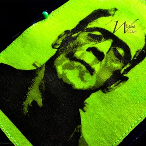 May include: A green fabric patch with a black and white image of Frankenstein's monster. The text "Wicked Wonder" is printed in the upper right corner of the patch.
