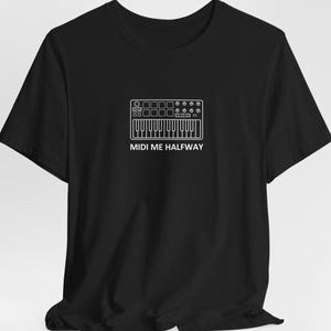 May include: Black t-shirt featuring a white line drawing of a MIDI keyboard and the text "MIDI ME HALFWAY". The design includes keys, knobs, and buttons, creating a minimalist music-themed graphic.