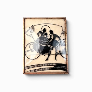 May include: A rectangular wall art piece featuring a black silhouette illustration of a couple in period clothing standing near a carriage, encased in a thin, weathered copper-toned metal frame with a light cream-colored background.