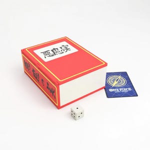 May include: A white ceramic mug with a black handle and the text "But First, Coffee" in a black, bold font. The mug is on a white surface.