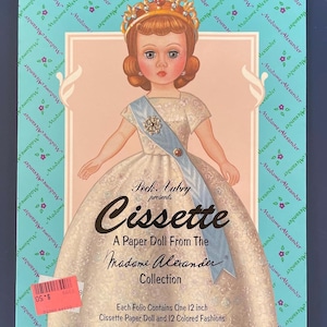 May include: A vintage Madame Alexander "Cissette" paper doll set. The box features a doll illustration wearing a crown, sash, and gown. Text includes "Cissette" and "A Paper Doll From The Madame Alexander Collection". The set includes a 12-inch doll and 12 colored fashions.