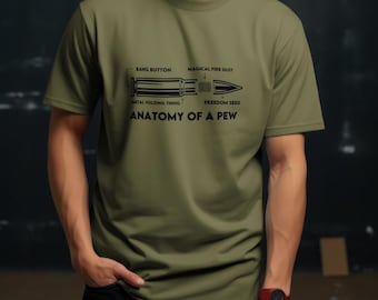 May include: A green t-shirt with a black graphic of a bullet with the text "Anatomy of a Pew" and the words "Bang Button", "Magical Fire Dust", "Metal Holding Thing", and "Freedom Seed" labeling the parts of the bullet.